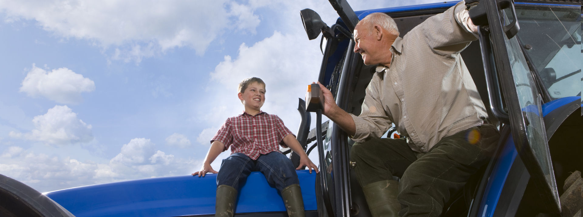 Grandfather and boy on tractor