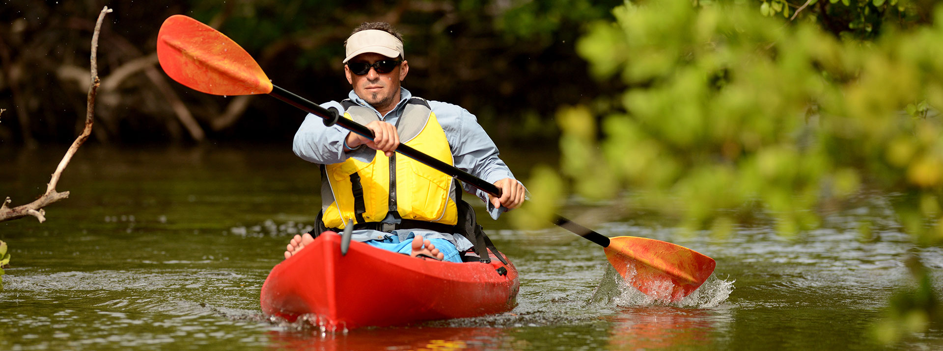 Man in orange kayak on river
